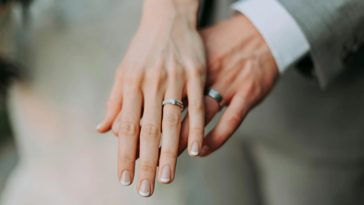 bride and groom showing their wedding rings