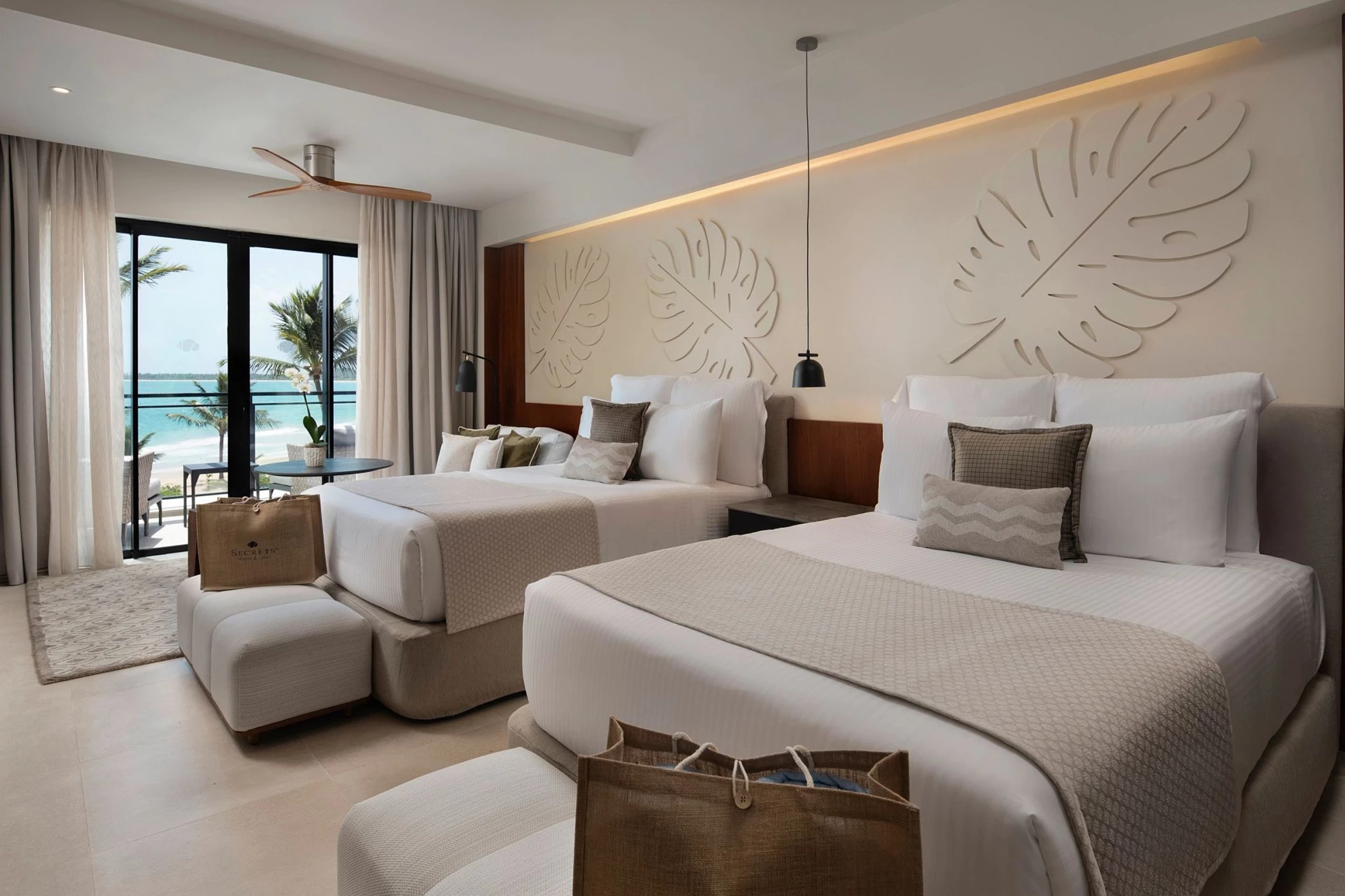 A preferred club junior suite with two beds and a balcony offering a beautiful oceanfront view.