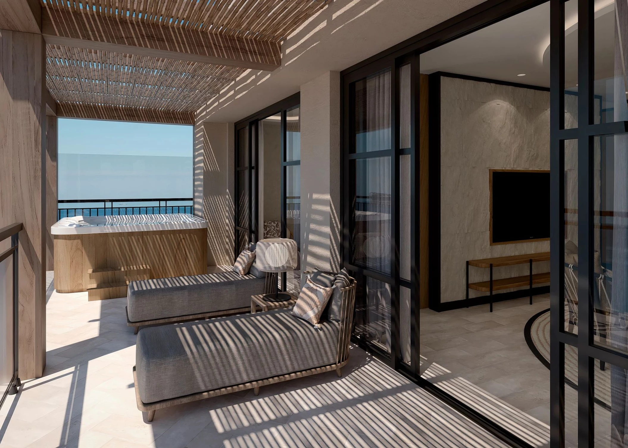 A luxurious presidential suite balcony with lounge chairs and a hot tub, with an ocean view.