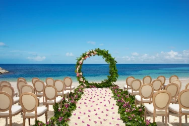 Ceremony setup on the Barracuda beach venue at Secrets Wild Orchid.