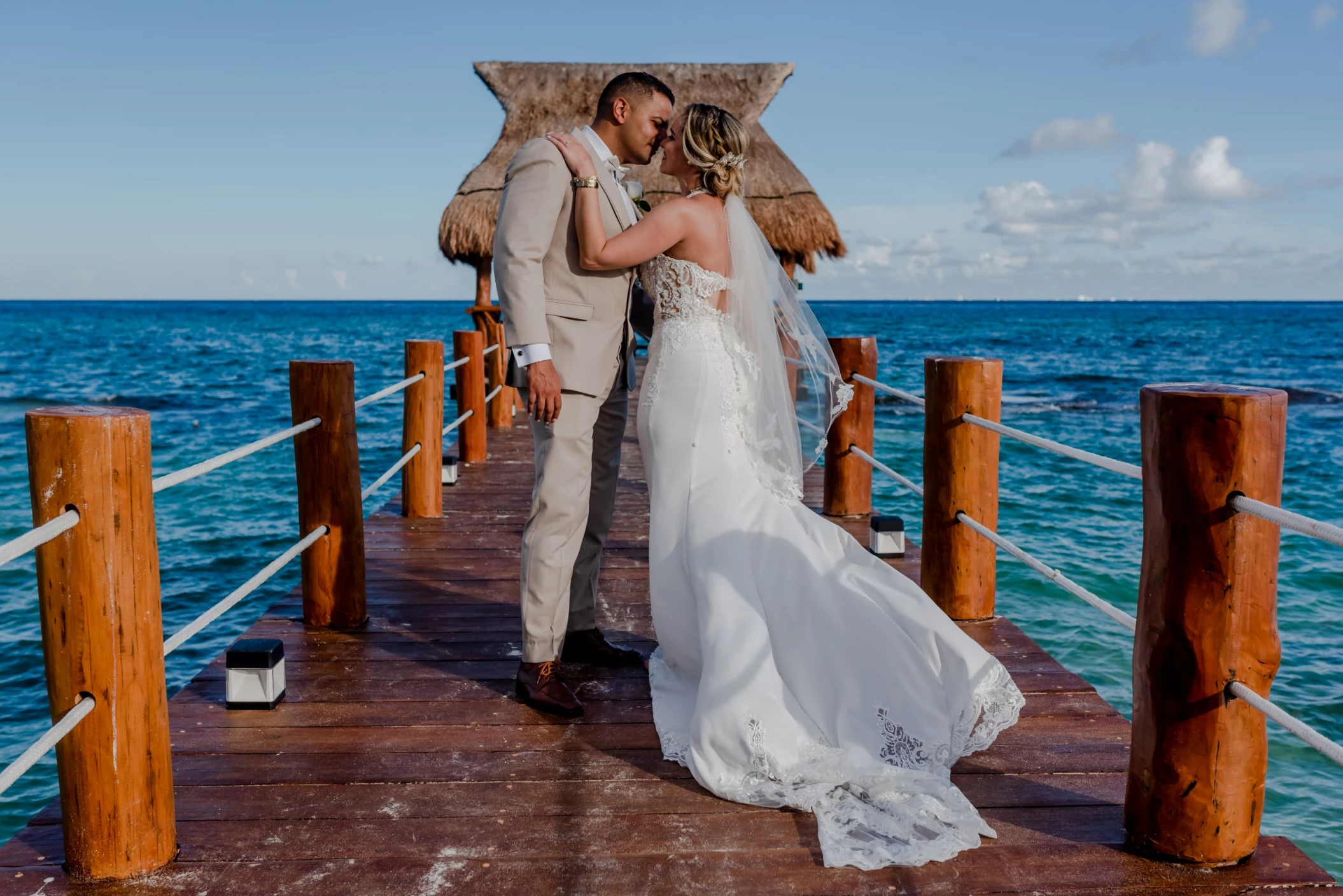 bride and groom at the pier at The Fives Beach Hotel & Residences