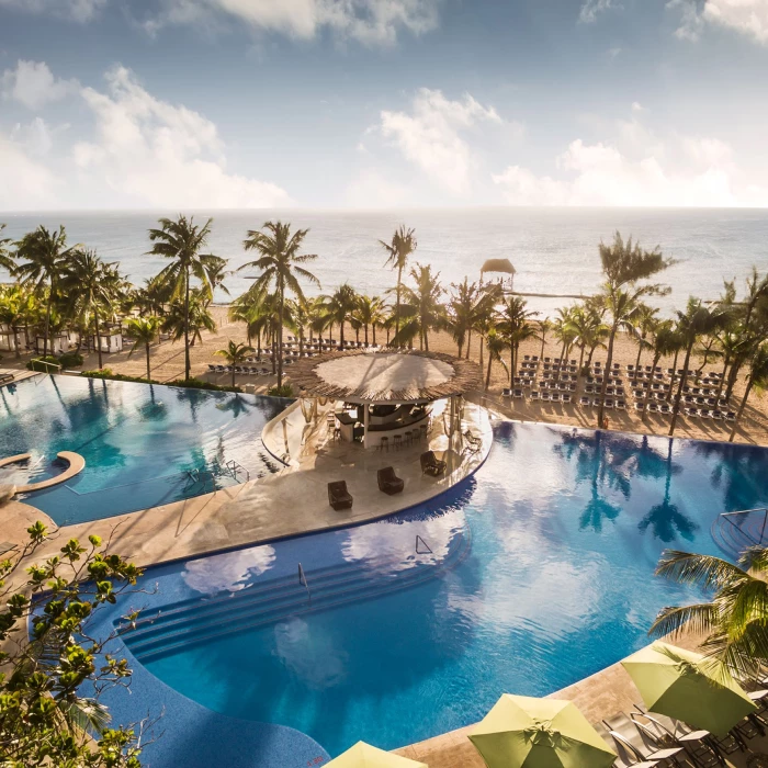 aerial view of the pools and beach at The Fives Beach Hotel & Residences