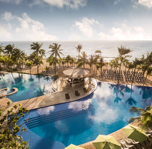 aerial view of the pools and beach at The Fives Beach Hotel & Residences