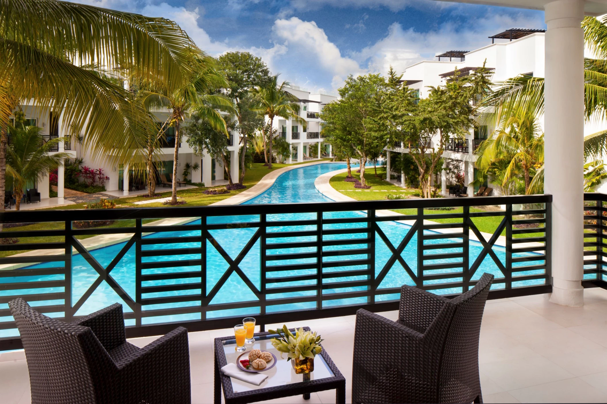 view of the pool from the balcony of a suite at The Fives Beach Hotel & Residences