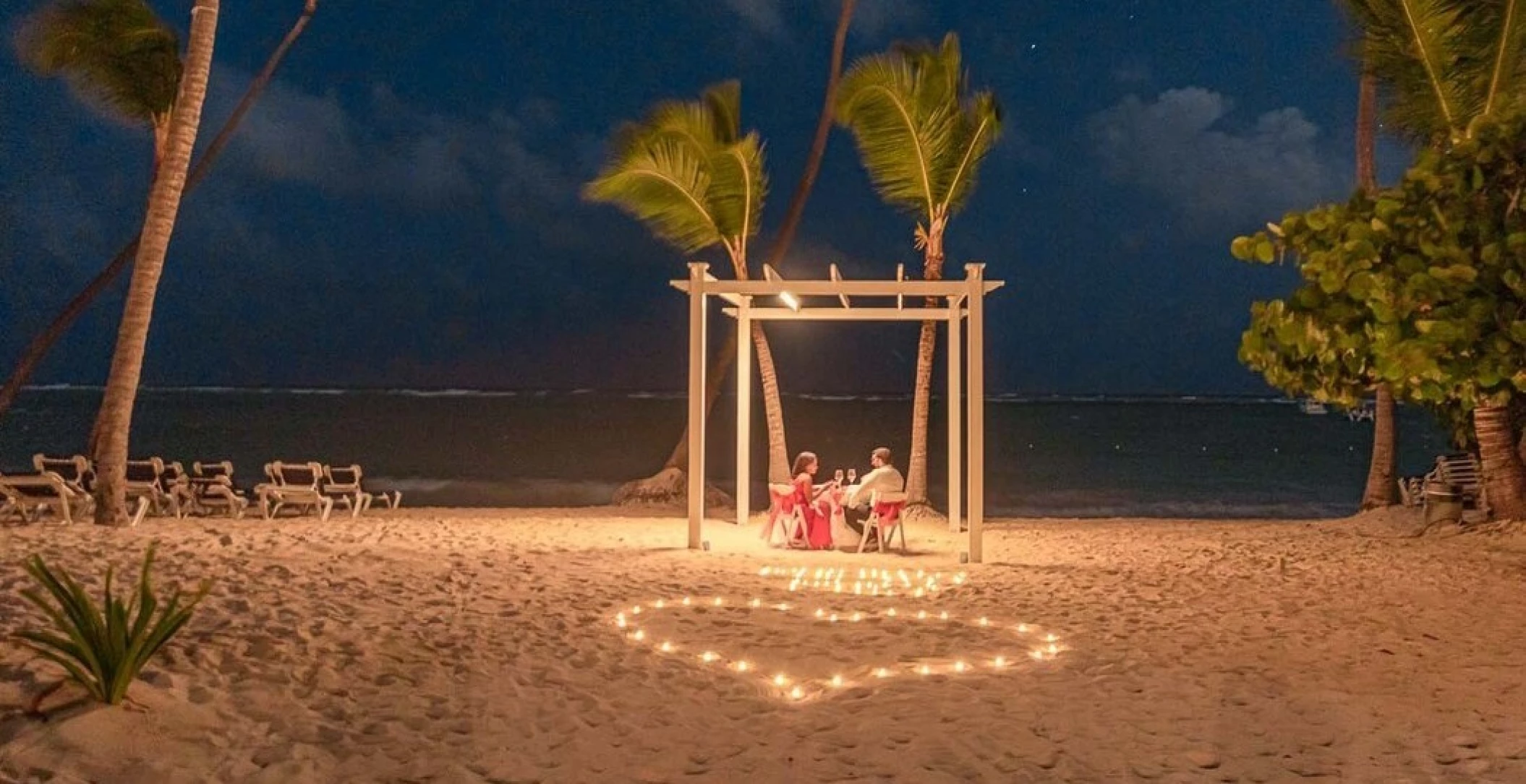 couple having romantic dinner on the beach at TRS Turquesa