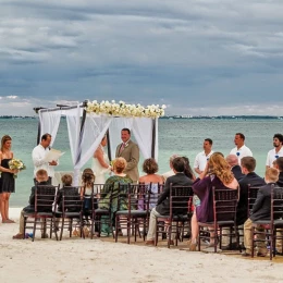 bride and groom and guests at the capricos beach venue ceremony at Villa del Palmar Cancun