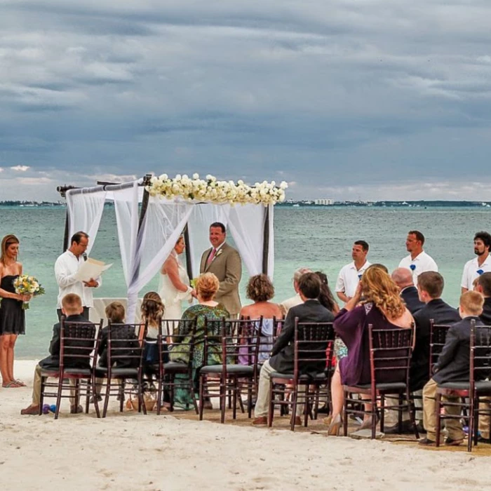 bride and groom and guests at the capricos beach venue ceremony at Villa del Palmar Cancun