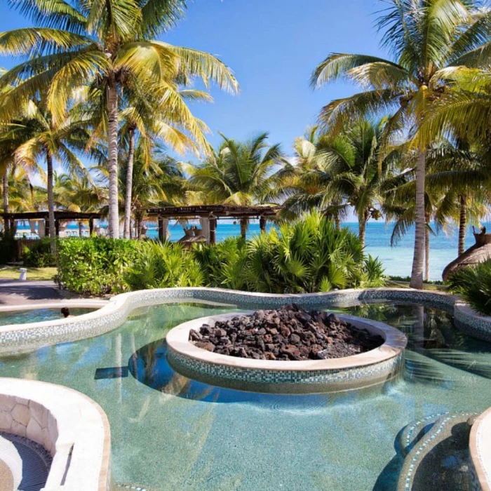 outdoor hot tub with fire pit at Villa del Palmar Cancun