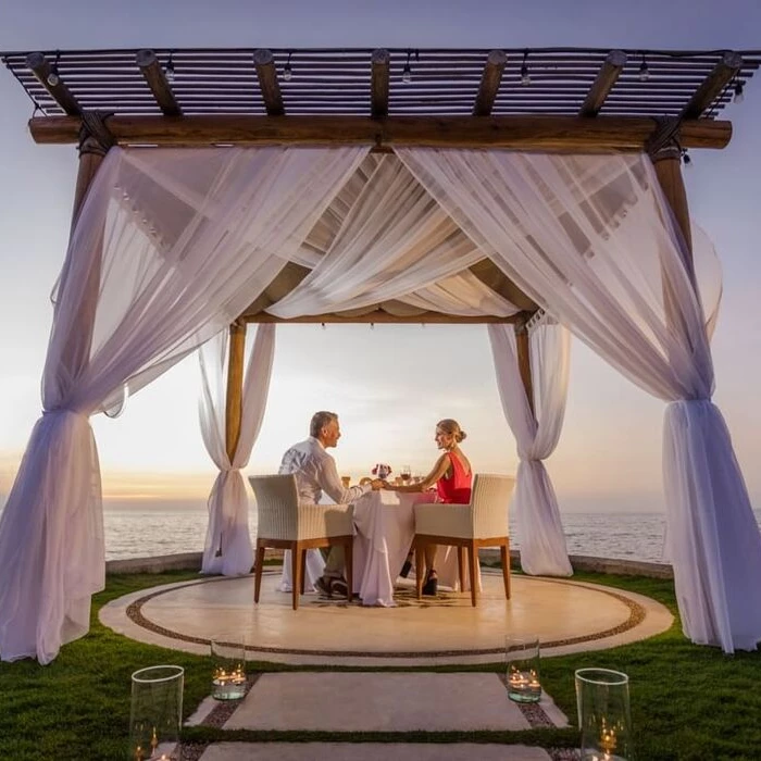 couple having a romantic dinner on the jetty at Villa Premiere Boutique Hotel