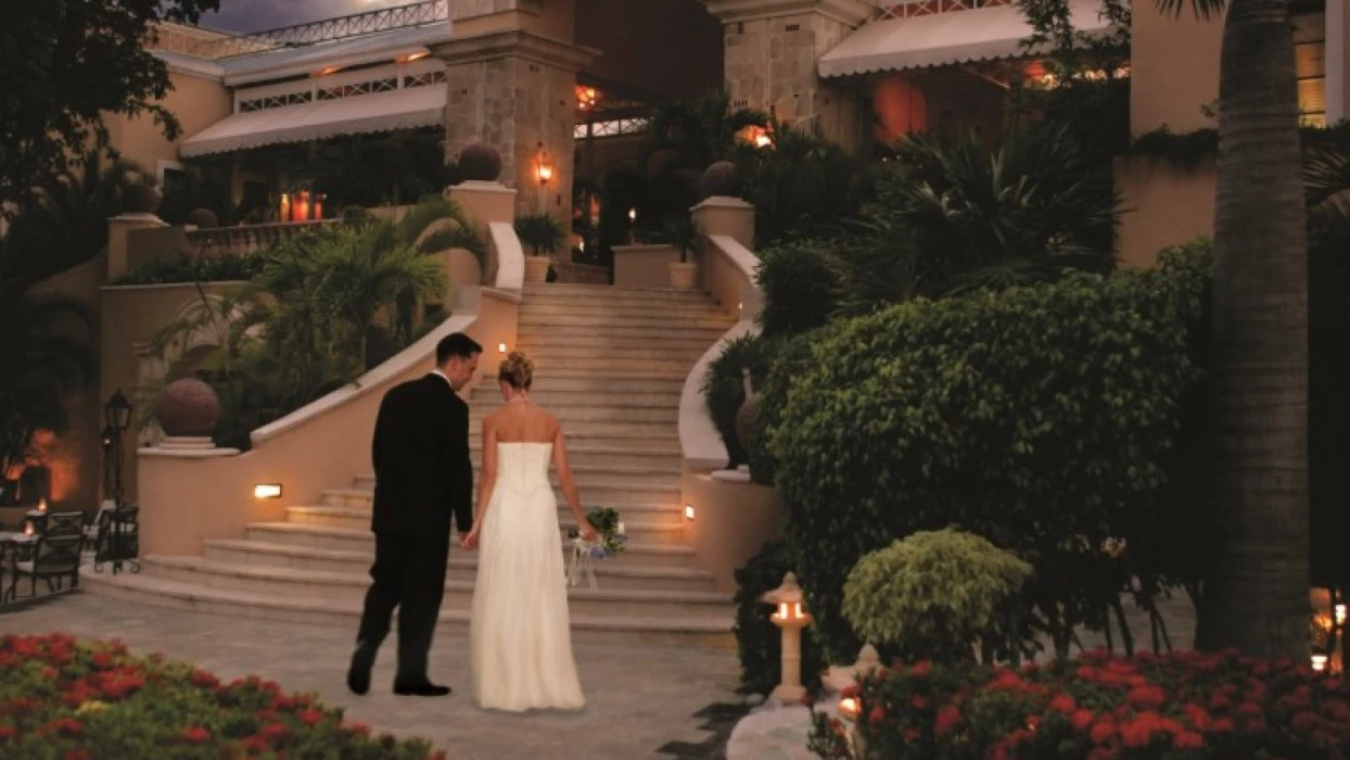 Royal Hideaway Playacar adults-only stairs with bride and groom