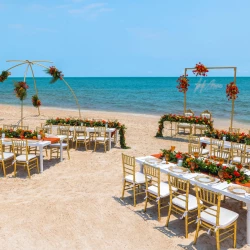 Wedding Ceremony and reception setup at beach venue on Royalton Splash Riviera Cancun