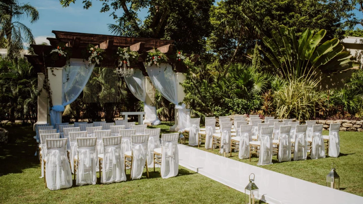 Ceremony decor on the garden wedding venue at Sandos Playacar Beach Resort