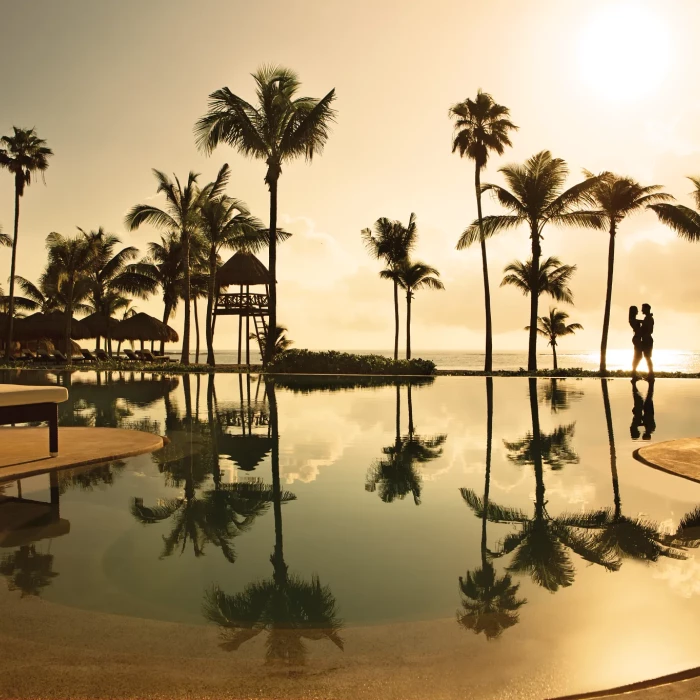 Secrets Akumal infinity pool at sunrise