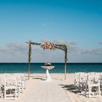 Ceremony decor on the beach wedding venue at Secrets Playa Mujeres Golf and Spa