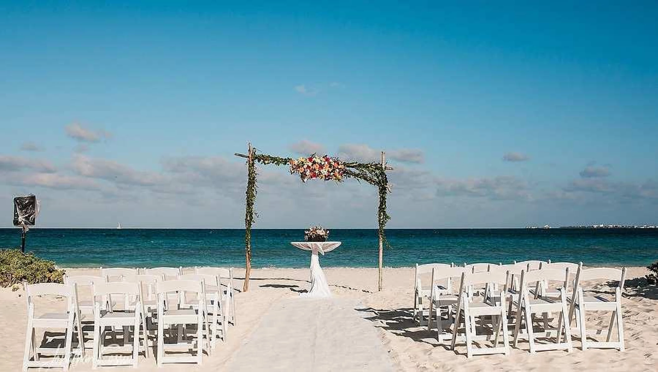 Ceremony decor on the beach wedding venue at Secrets Playa Mujeres Golf and Spa