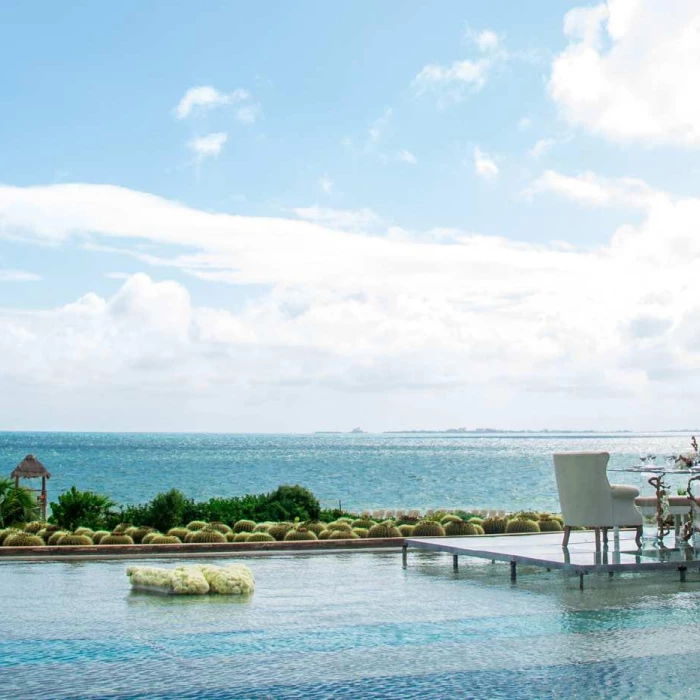 Intimate dinner on the over water infinity pool at Secrets Playa Mujeres Golf and Spa