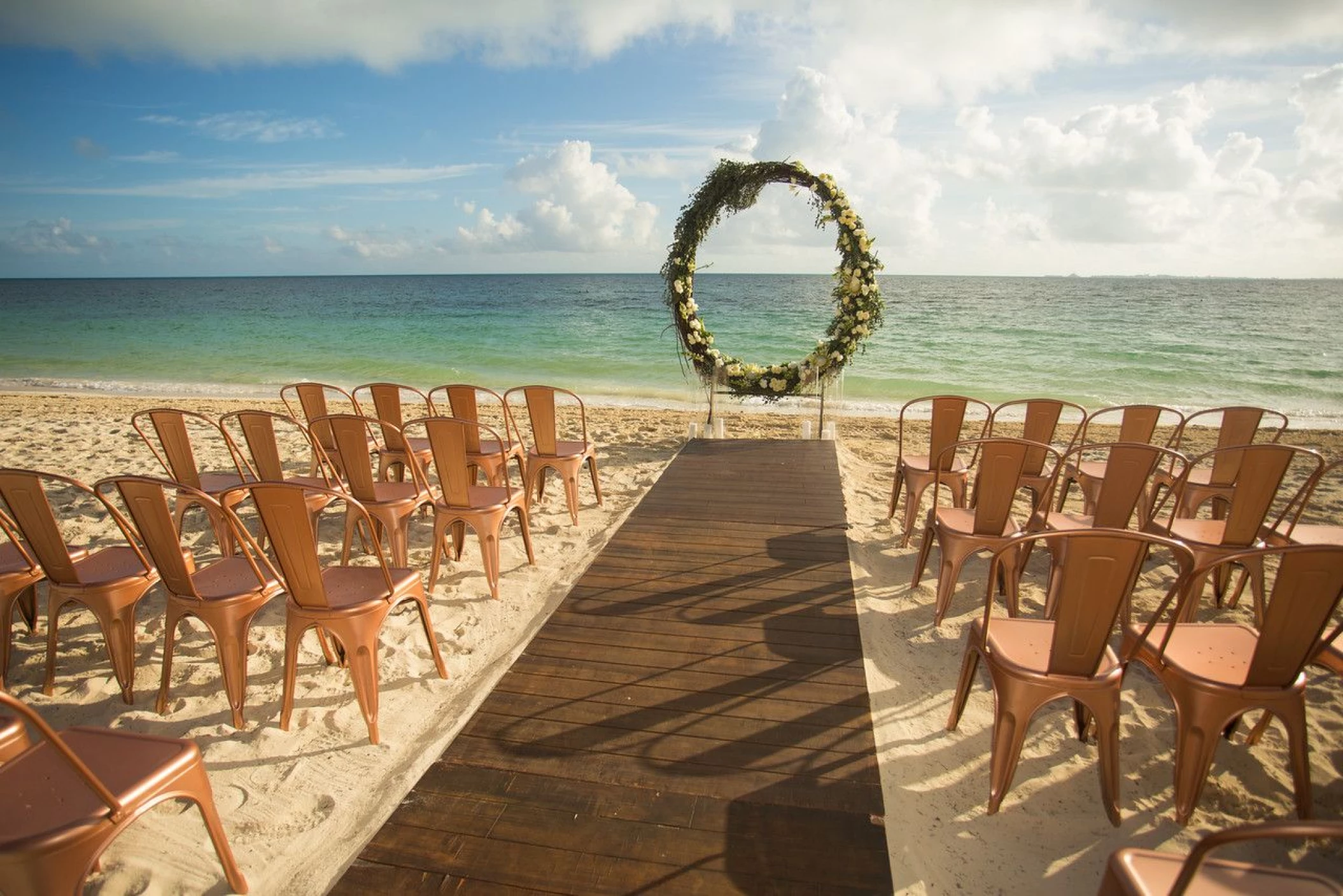 Ceremony decor on the beach wedding venue at Secrets Playa Mujeres Golf and Spa