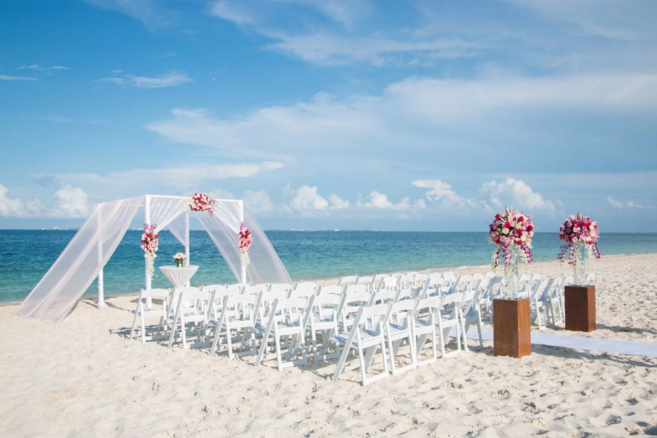 Ceremony decor on the beach wedding venue at Secrets Playa Mujeres Golf and Spa