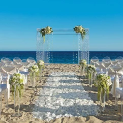 Ceremony decor on the beach wedding venue at Secrets Puerto Los Cabos Golf & Spa Resort