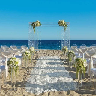 Ceremony decor on the beach wedding venue at Secrets Puerto Los Cabos Golf & Spa Resort