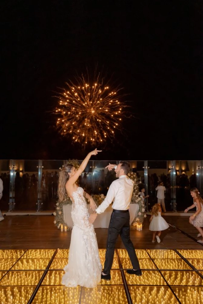 Andreana and Alessandro on the dance floor with fireworks in the background