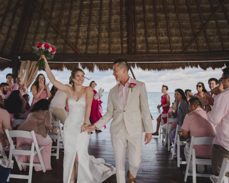 Kayla & Johnny as husband and wife surrounded by their guests