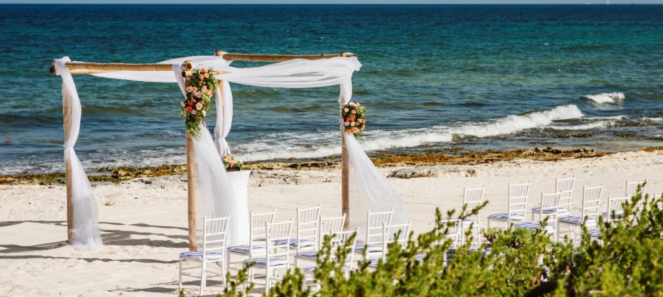 Ceremony decor on the beach wedding venue at Valentin Imperial Riviera Maya