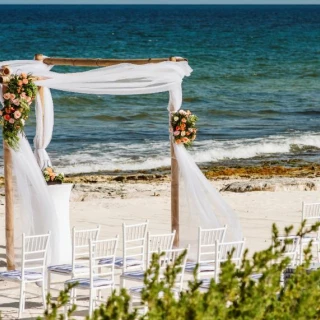 Ceremony decor on the beach wedding venue at Valentin Imperial Riviera Maya