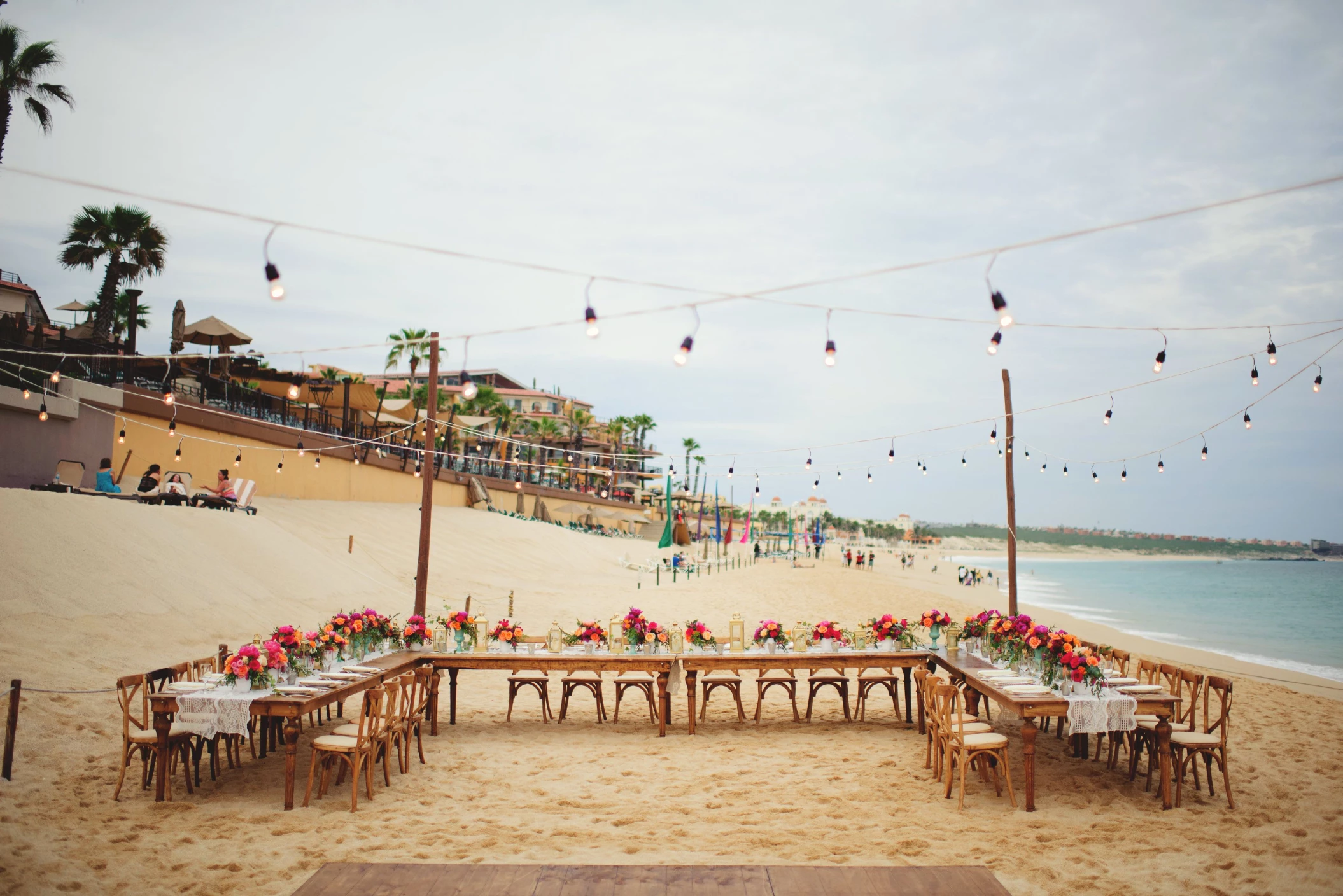 Dinner reception decor on the beach wedding venue at Villa La Estancia Los Cabos