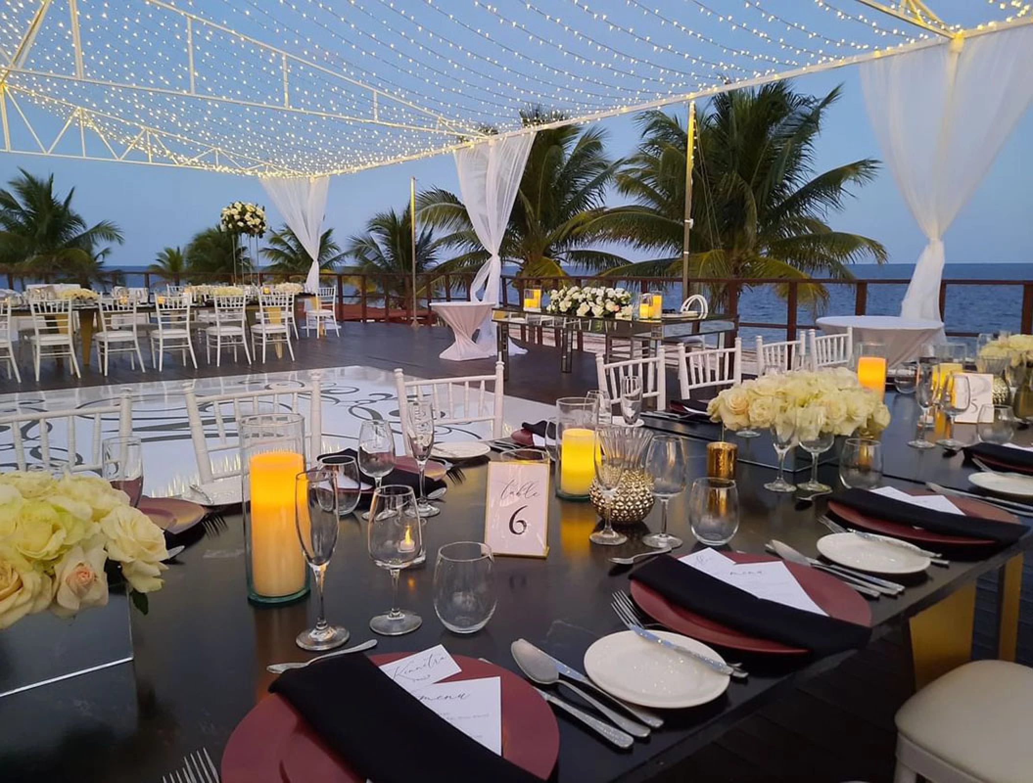 Reception setup at Vora Deck wedding venue at Haven Riviera Cancun Resort.