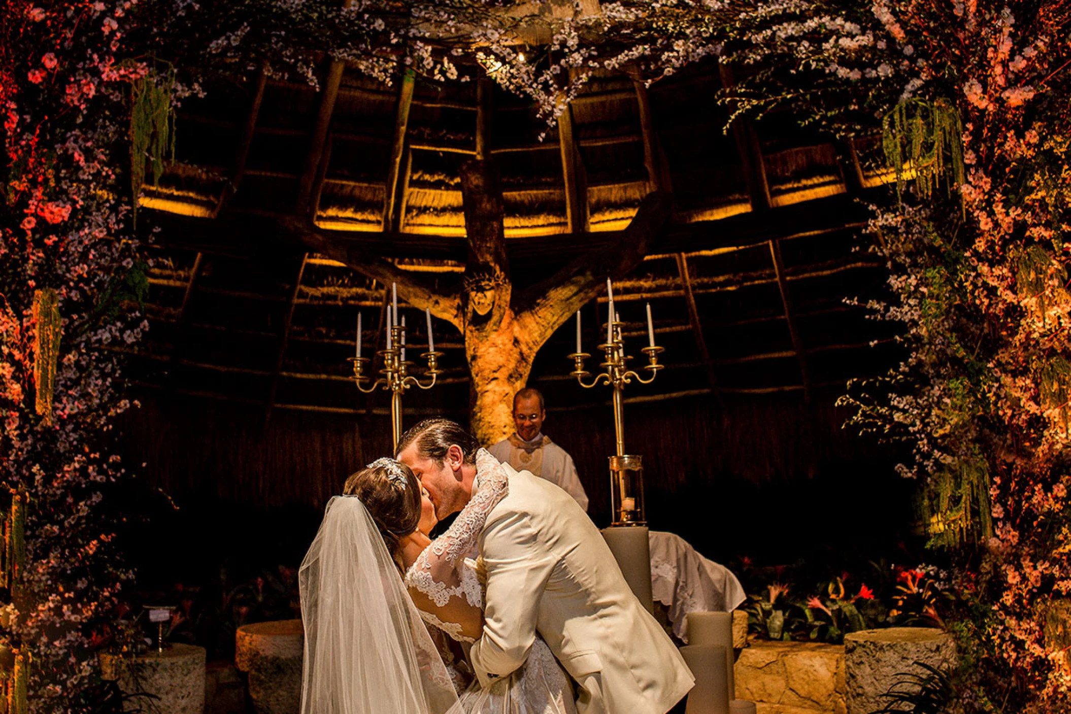 Wedding couple kisses on Xcaret's chapel's altar.