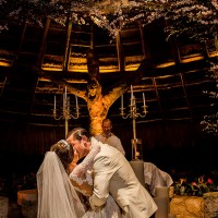 Wedding couple kisses on Xcaret's chapel's altar.