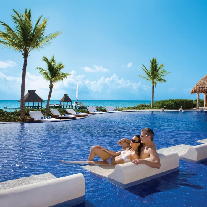 Couple in the main pool at Zoetry Paraiso de la Bonita Riviera Maya