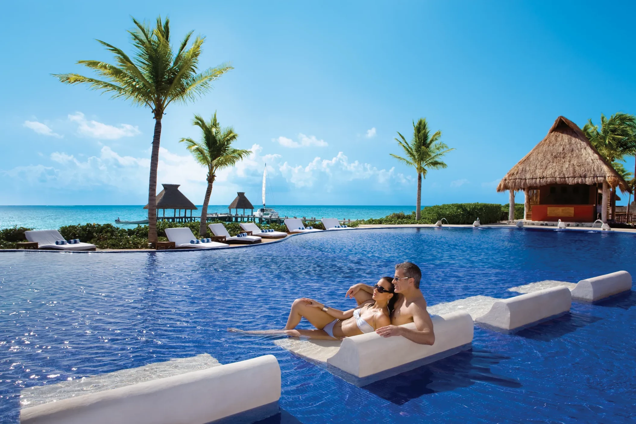 Couple in the main pool at Zoetry Paraiso de la Bonita Riviera Maya